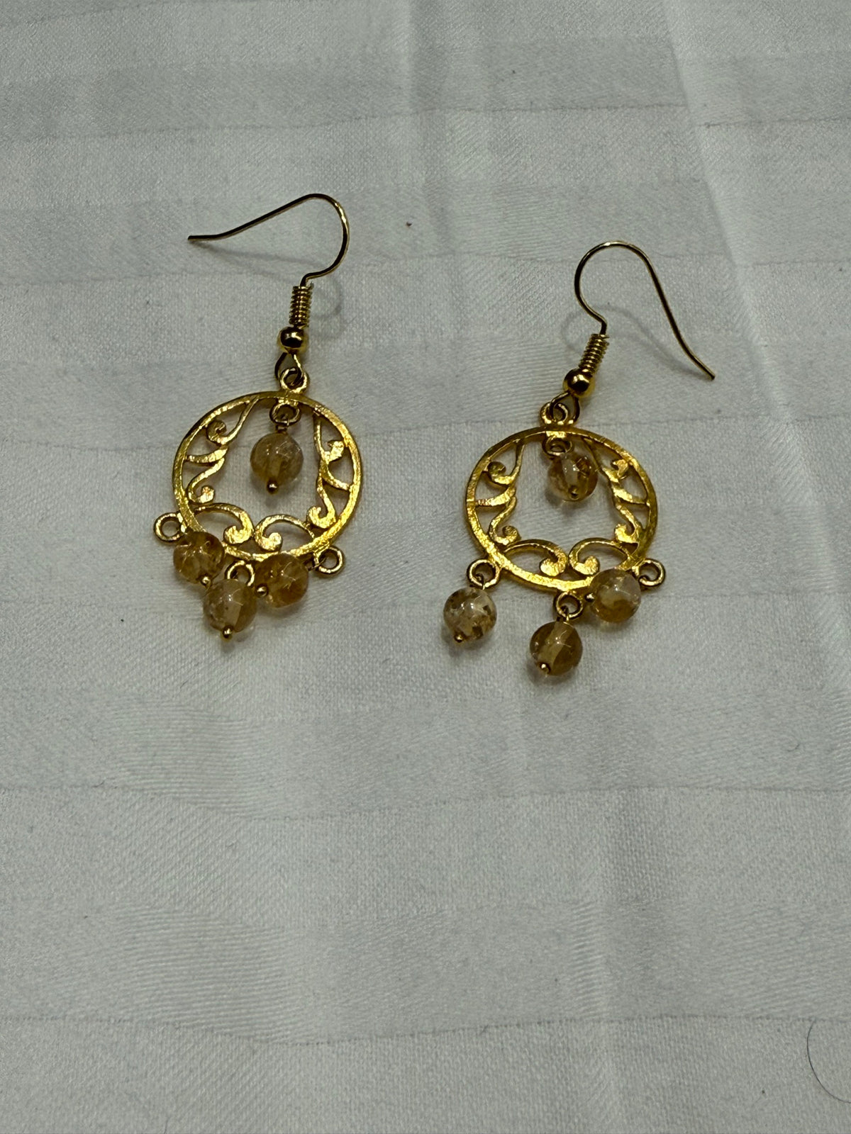 Nomi AM-67 — gold tone